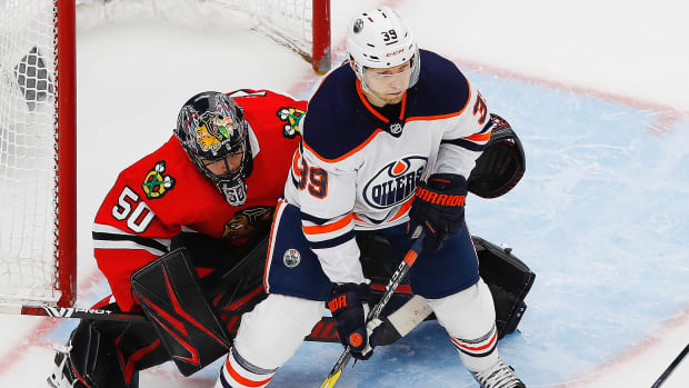 Edmonton Oilers forward Alex Chiasson (39) tries to screen Chicago Blackhawks goaltender Corey Crawford (50) during the third period in the Western Conference qualifications at Rogers Place.